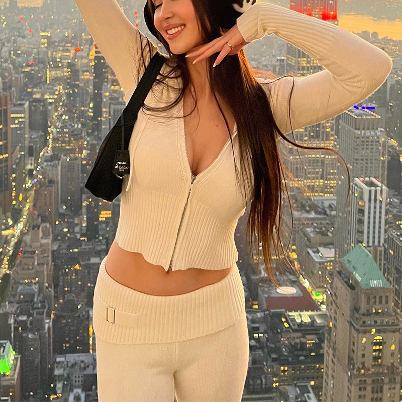 Woman in ribbed knit hoodie and flare pants set