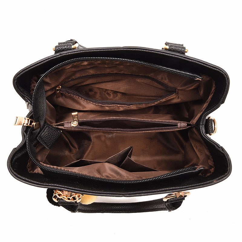 Embossed handbag with pompom charm