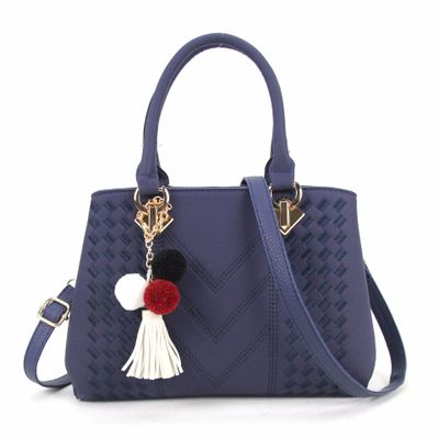 Embossed handbag with pompom charm