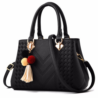 Embossed handbag with pompom charm