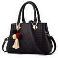 Embossed handbag with pompom charm