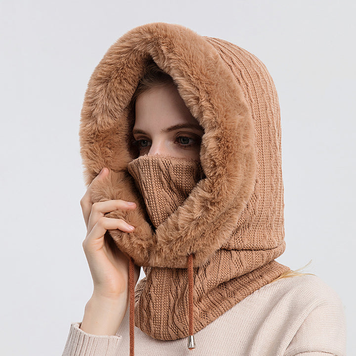 Woman wearing knit hood with faux fur trim