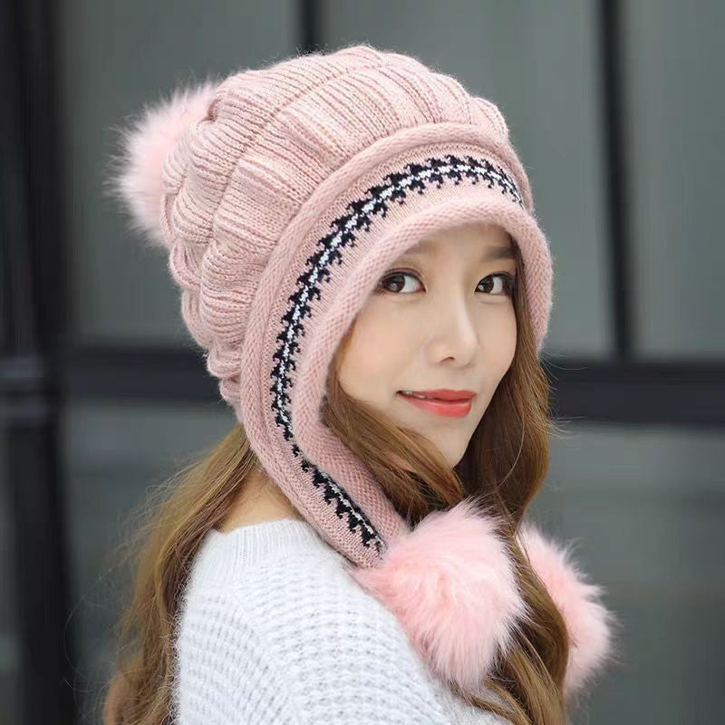 Woman in an ear flap beanie with pompom