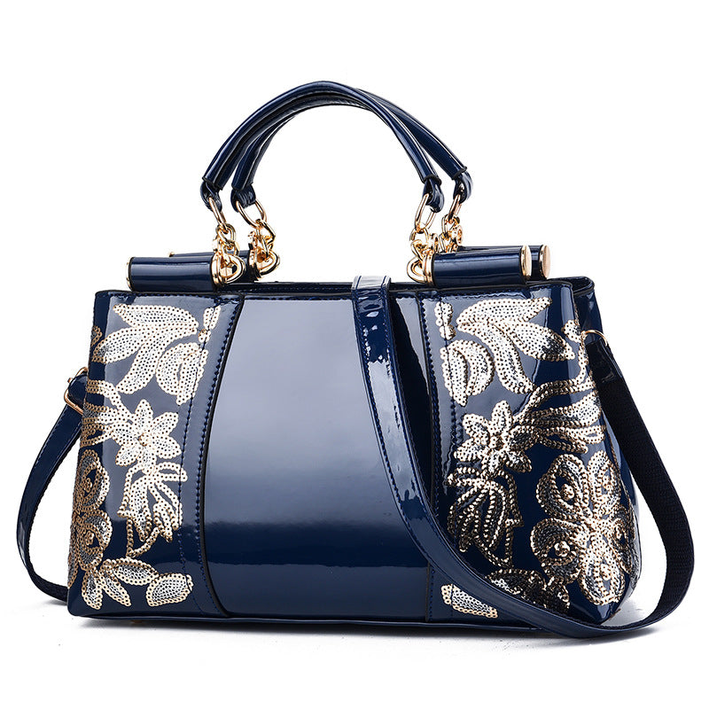 Sequin embroidered patent leather handbag
