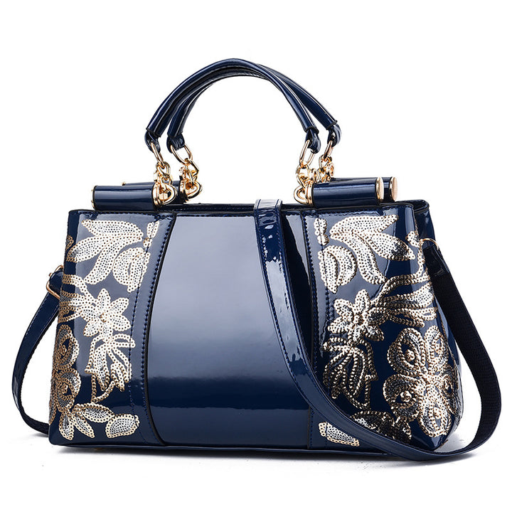 Sequin embroidered patent leather handbag