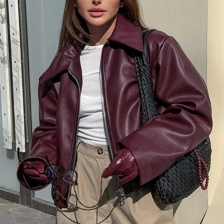 Woman in a cropped burgundy leather jacket