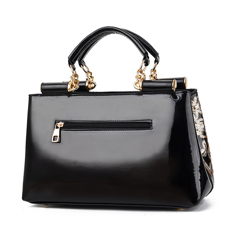 Sequin embroidered patent leather handbag