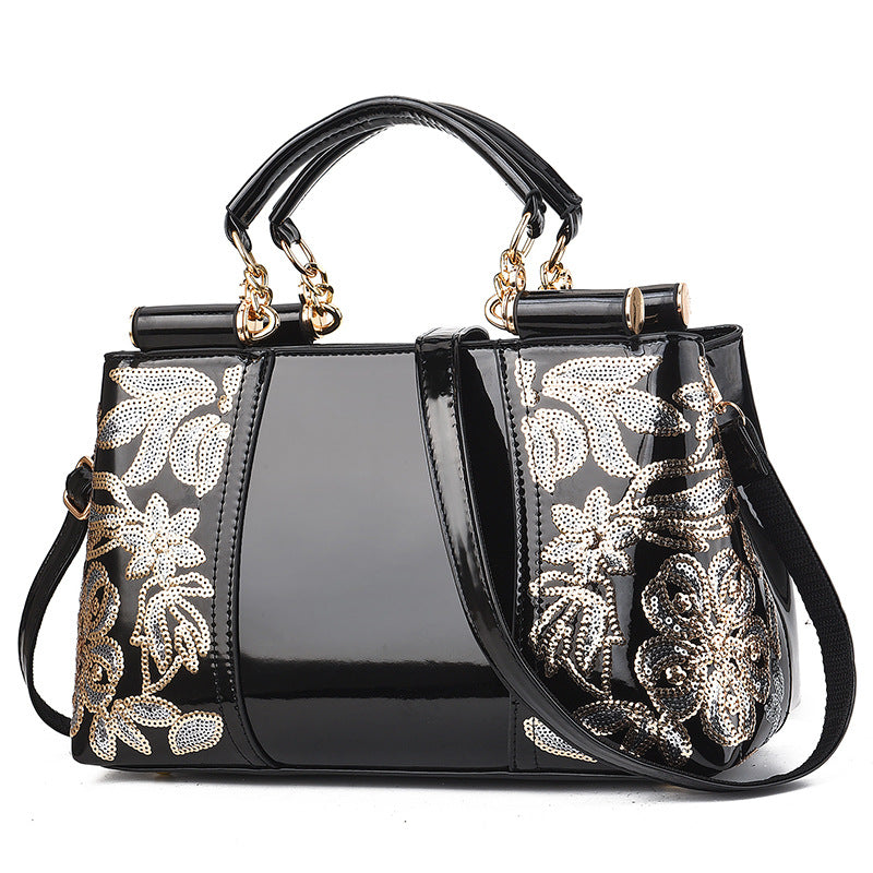 Sequin embroidered patent leather handbag